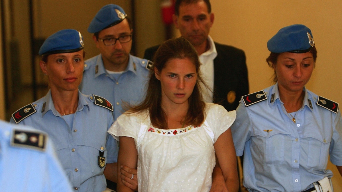 Amadna Knox is escorted by Italian police