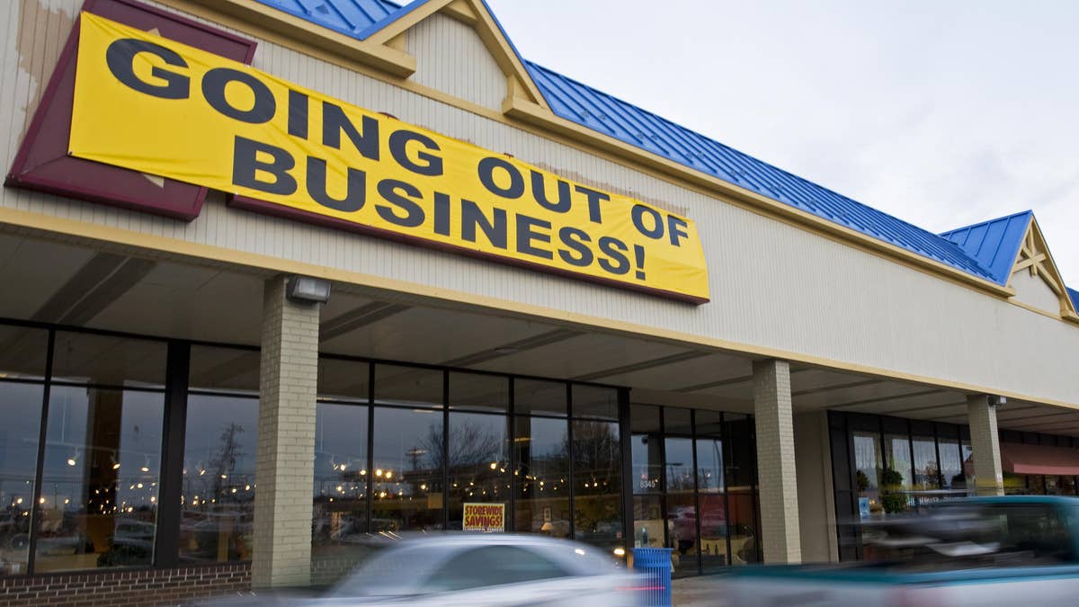 yellow "going out of business" sign over storefront