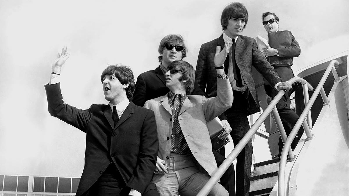 The Beatles leaving an airplane