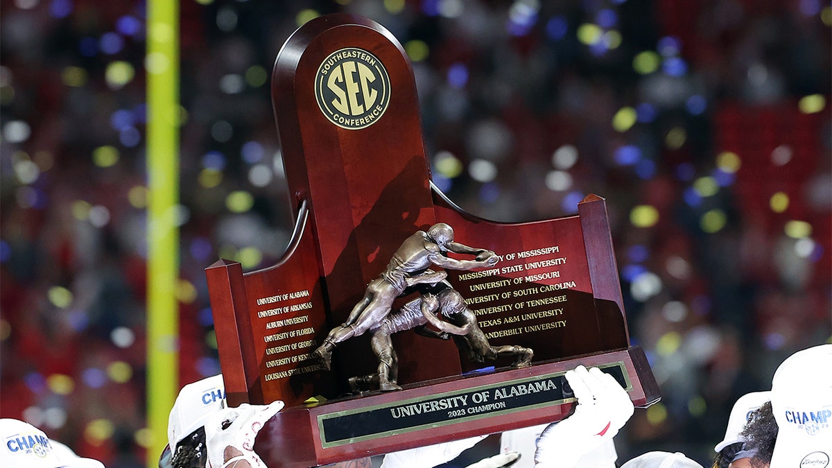 Alabama holds the SEC Championship trophy