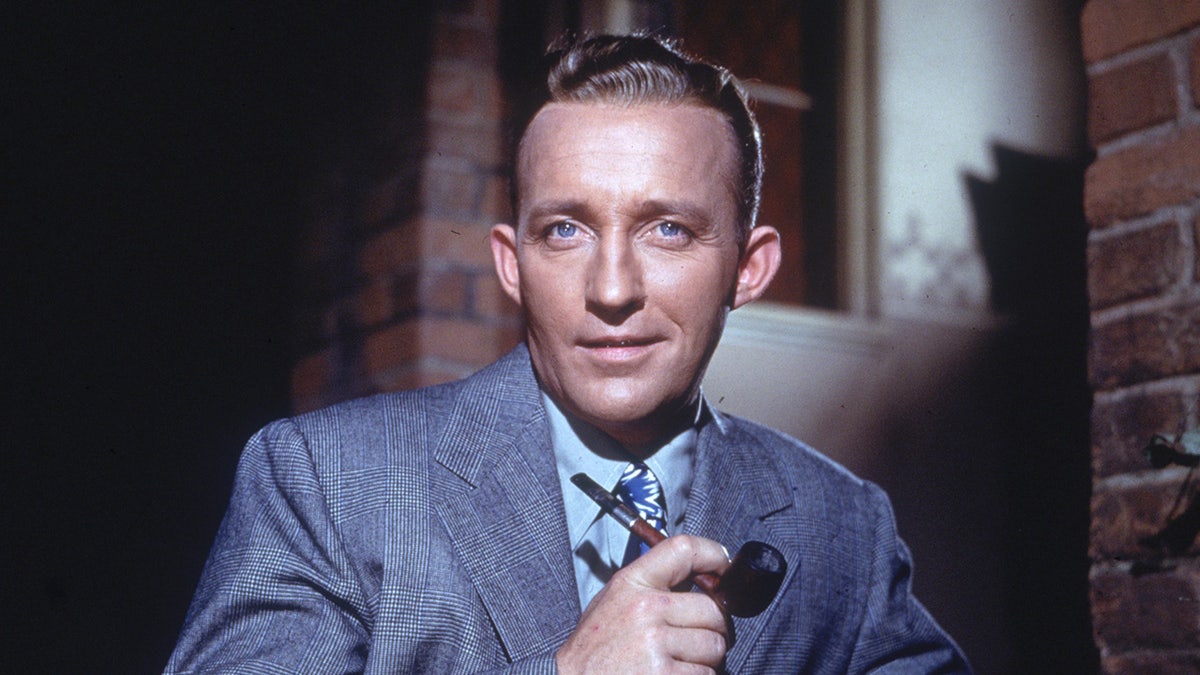 A close-up of Bing Crosby holding a pipe