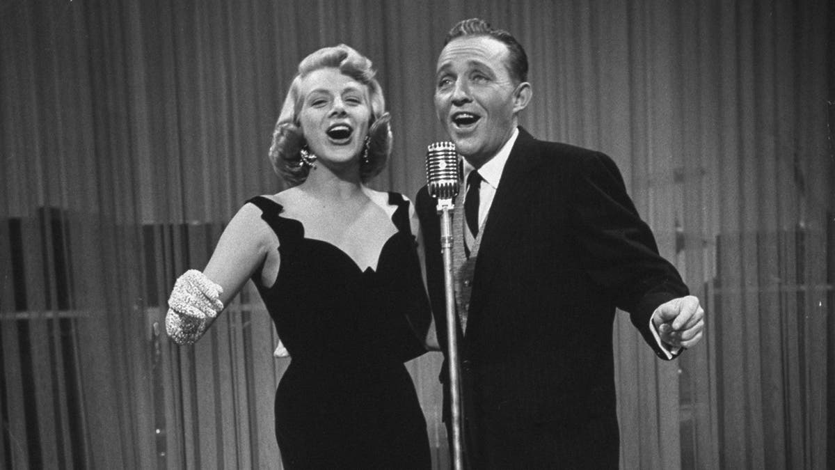 Rosemary Clooney and Bing Crosby singing in front of a mic