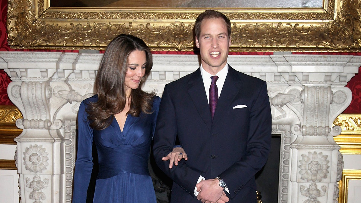 Kate Middleton admiring her engagement ring in the arms of Prince William