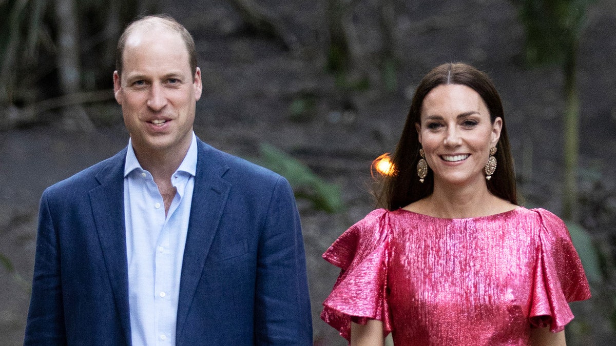 Prince William in a casual blue suit next to Kate Middleton in a sparkly pink gown