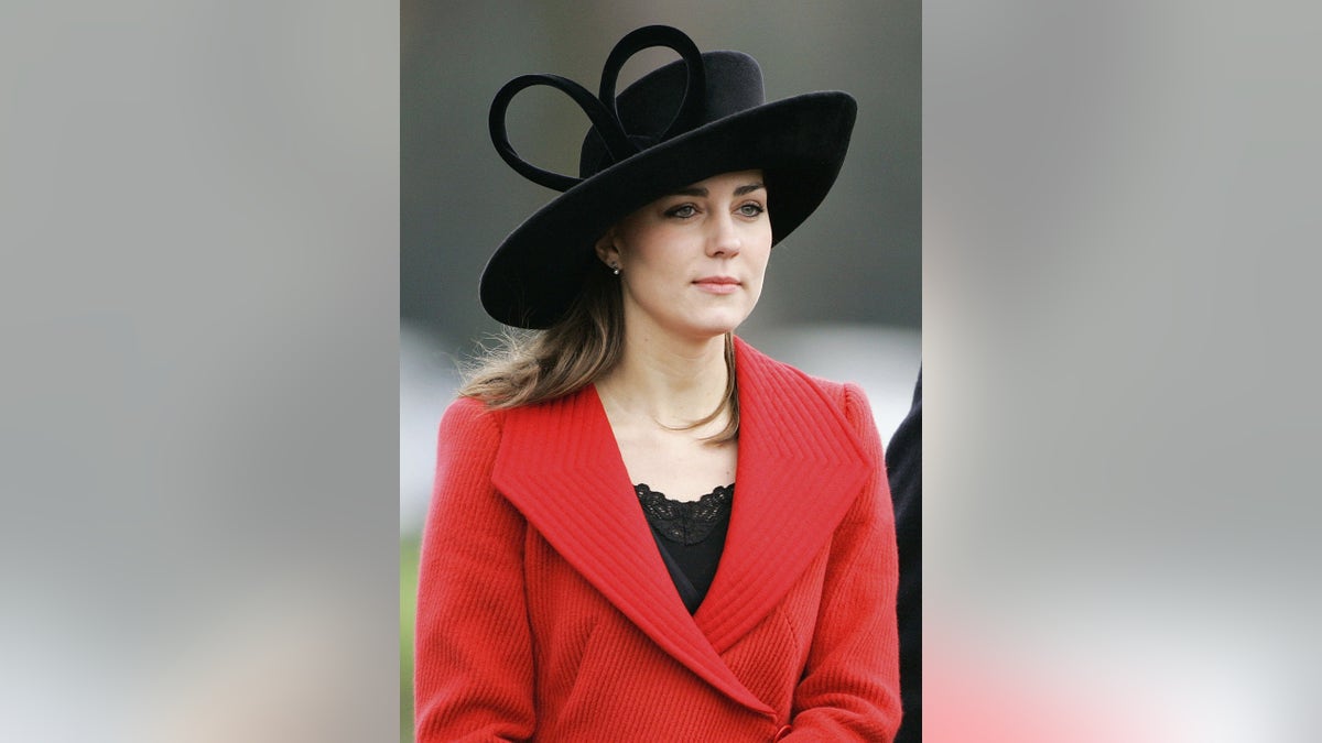 Kate Middleton wearing a red coat and black hat