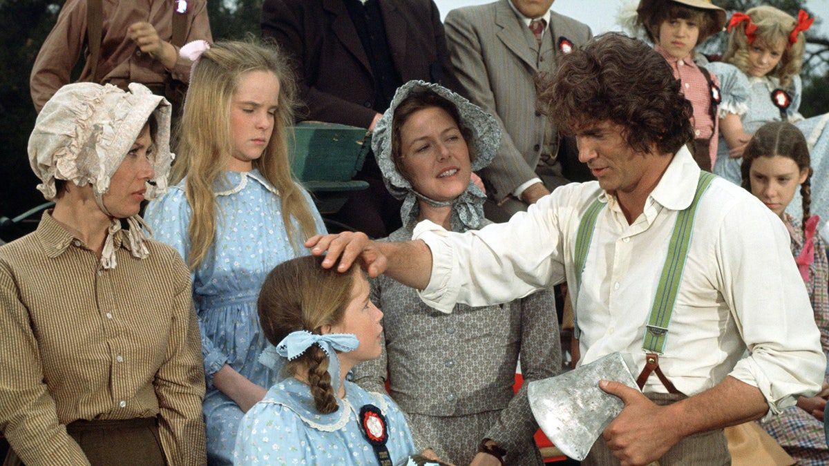 The cast of Little House on the Prairie in costume getting ready to film