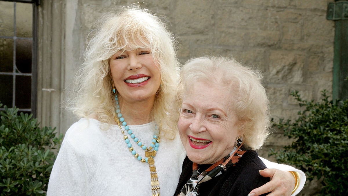 Loretta Swit smiling embracing Betty White