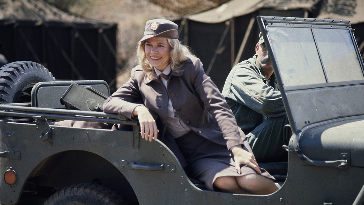 Loretta Swit sitting in a jeep during the filming of television show M*A*S*H