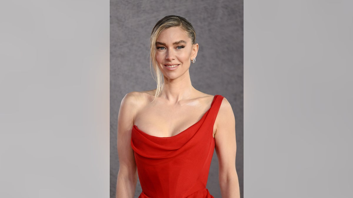 A close-up of Vanessa Kirby wearing a red one shoulder dress