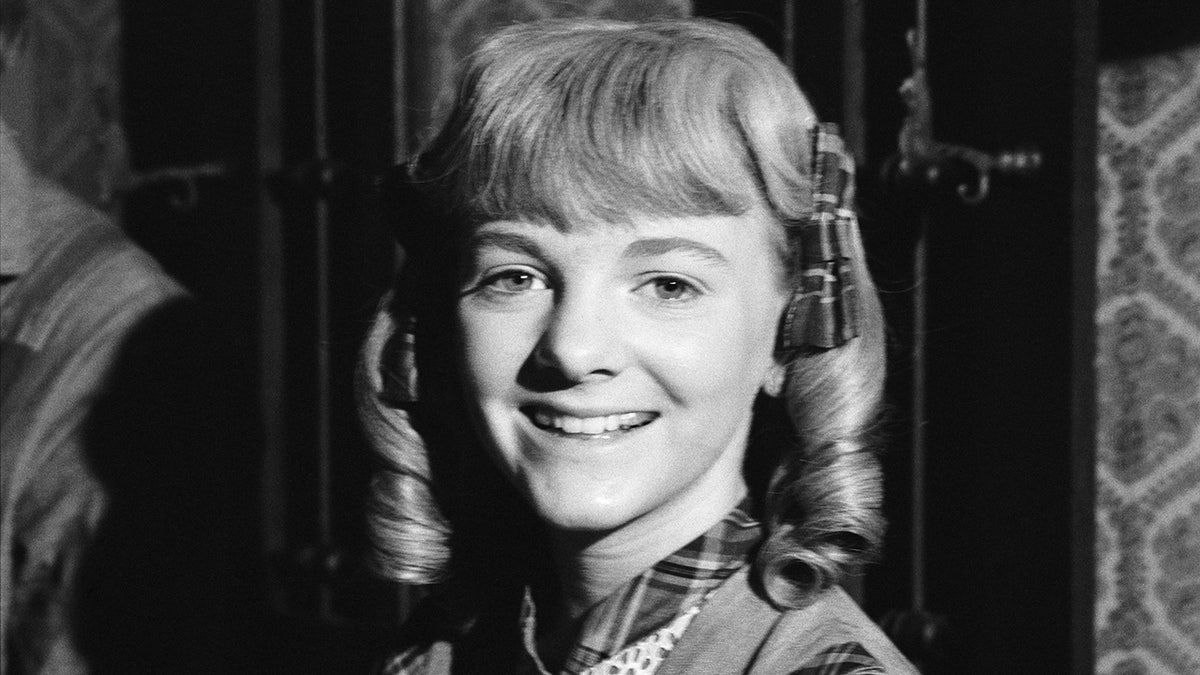 A close-up of Alison Arngrim smiling as Nellie Oleson