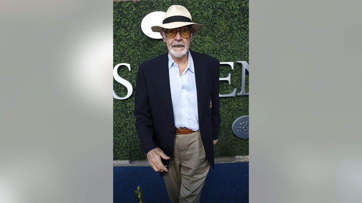 Sean Connery wearing a blue blazer and a white shirt with a hat