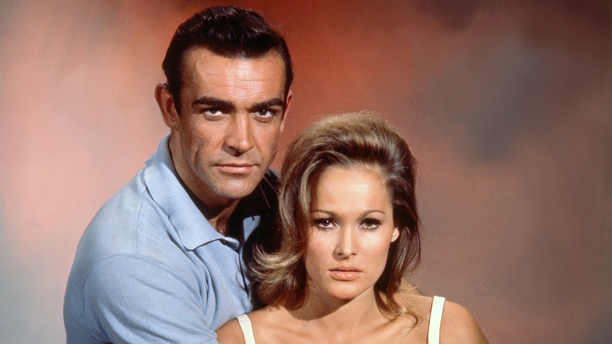 Sean Connery leaning into Ursula Andress in a promotional photo for a James Bond film