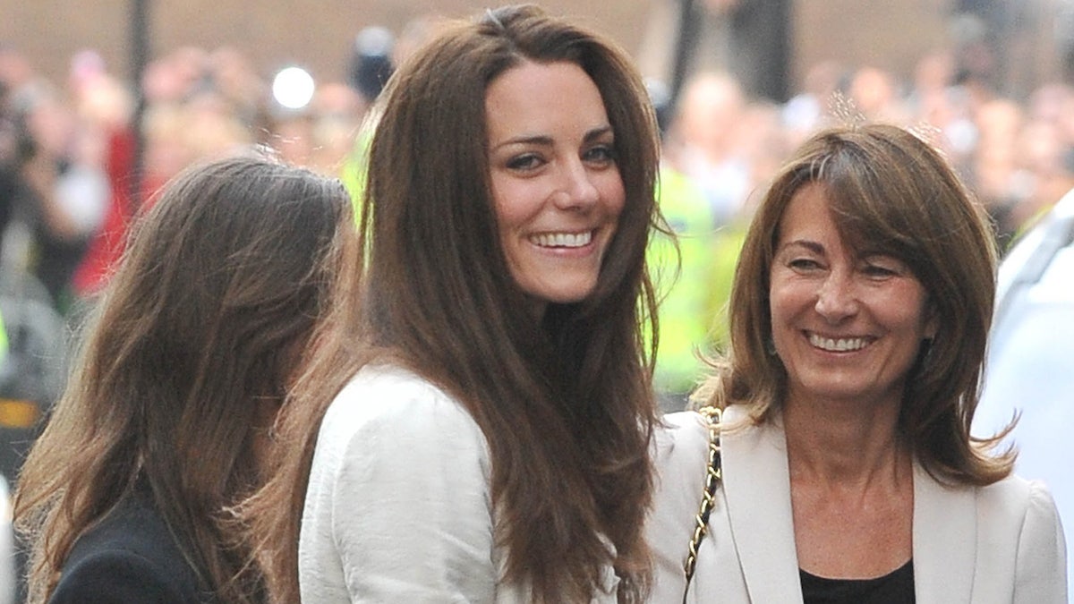 Carole Middleton smiling at her daughter Kate Middleton who looks directly at the camera