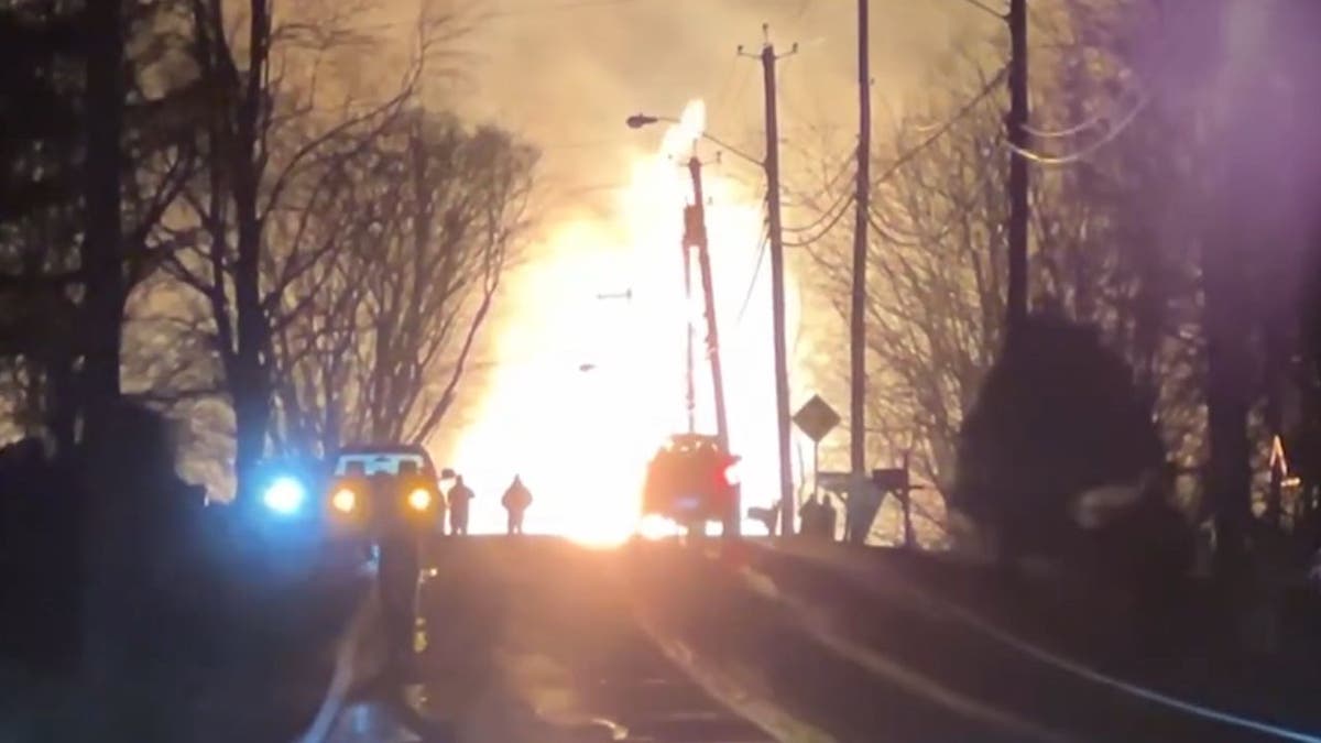 A night time shot of a large fire caused by a tractor-trailer hitting a bridge