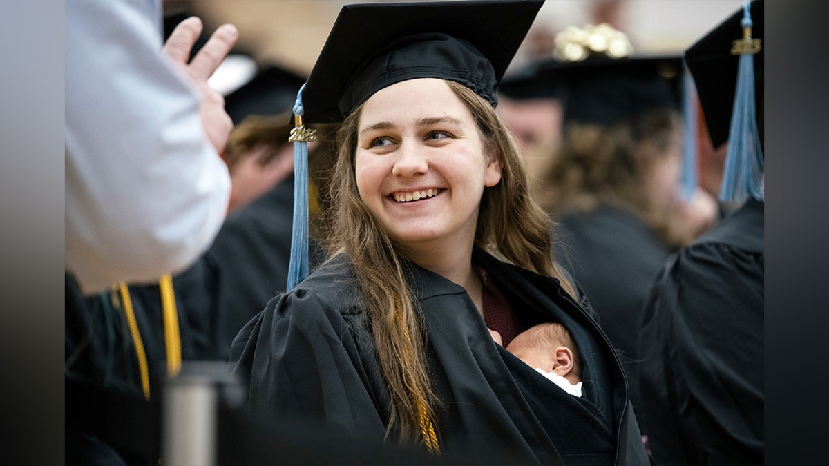 Grace Szymchack smiling at her college graduation