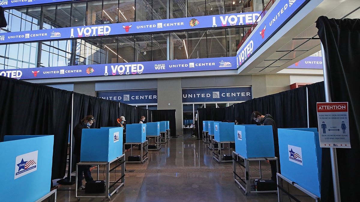 Illinois voters use voting machines set up in the east atrium of the United Center on Nov. 3, 2020, in Chicago. Eric Hendricks, an incumbent member of the McHenry County Board, has filed an objection against his primary opponent, Bob Nowak.