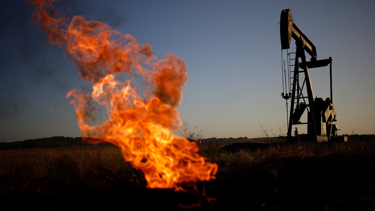 A natural gas flare burns near an oil pump jack at the New Harmony Oil Field in Grayville, Illinois, US, on Sunday, June 19, 2022. Top Biden administration officials are weighing limits on exports of fuel as the White House struggles to contain gasoline prices that have topped $5 per gallon. Photographer: Luke Sharrett/Bloomberg via Getty Images