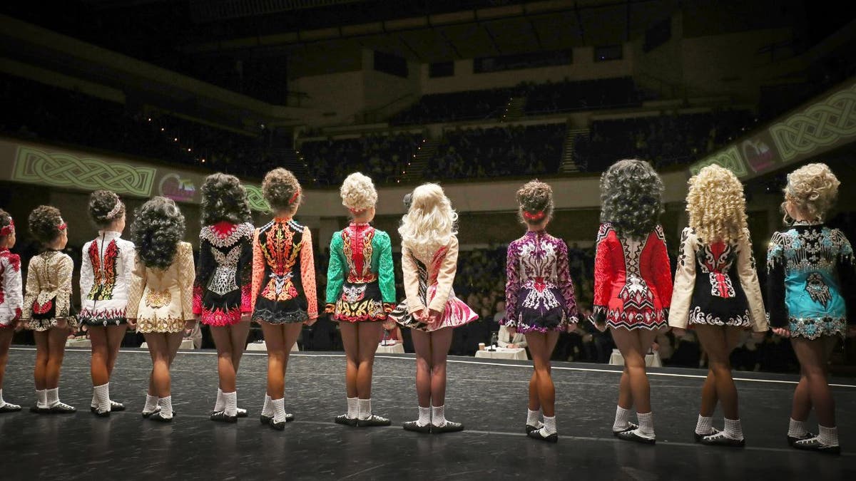 A group of girls competing in an irish dance tournament