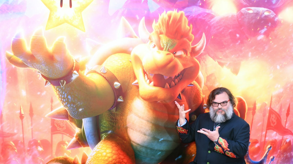 Jack Black posing with his character poster on the red carpet