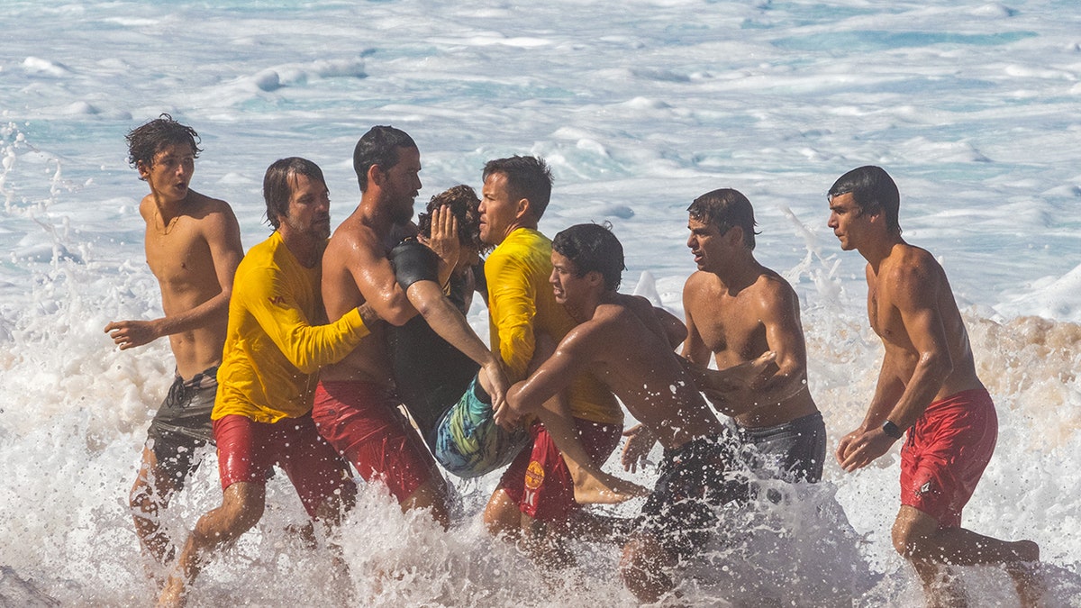 Joao Chianca helped out of the water