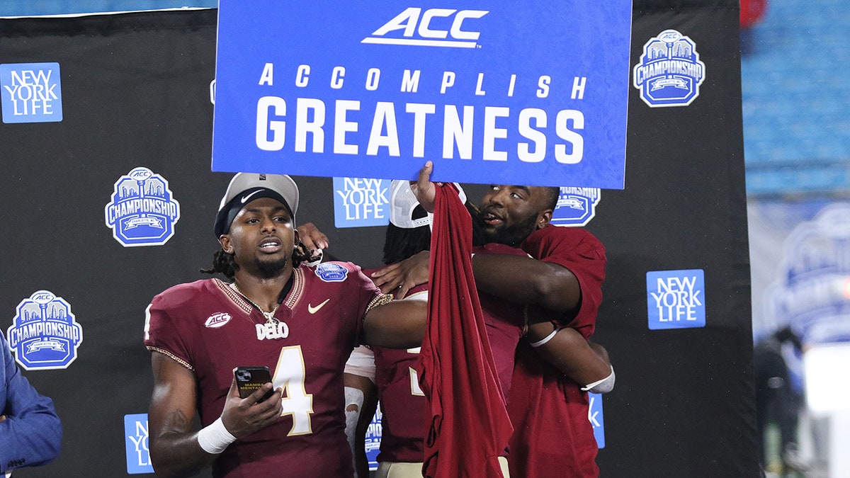 Trump blasts CFP officials after Florida State left out, takes parting shot at DeSantis 2 FSU players celebrate