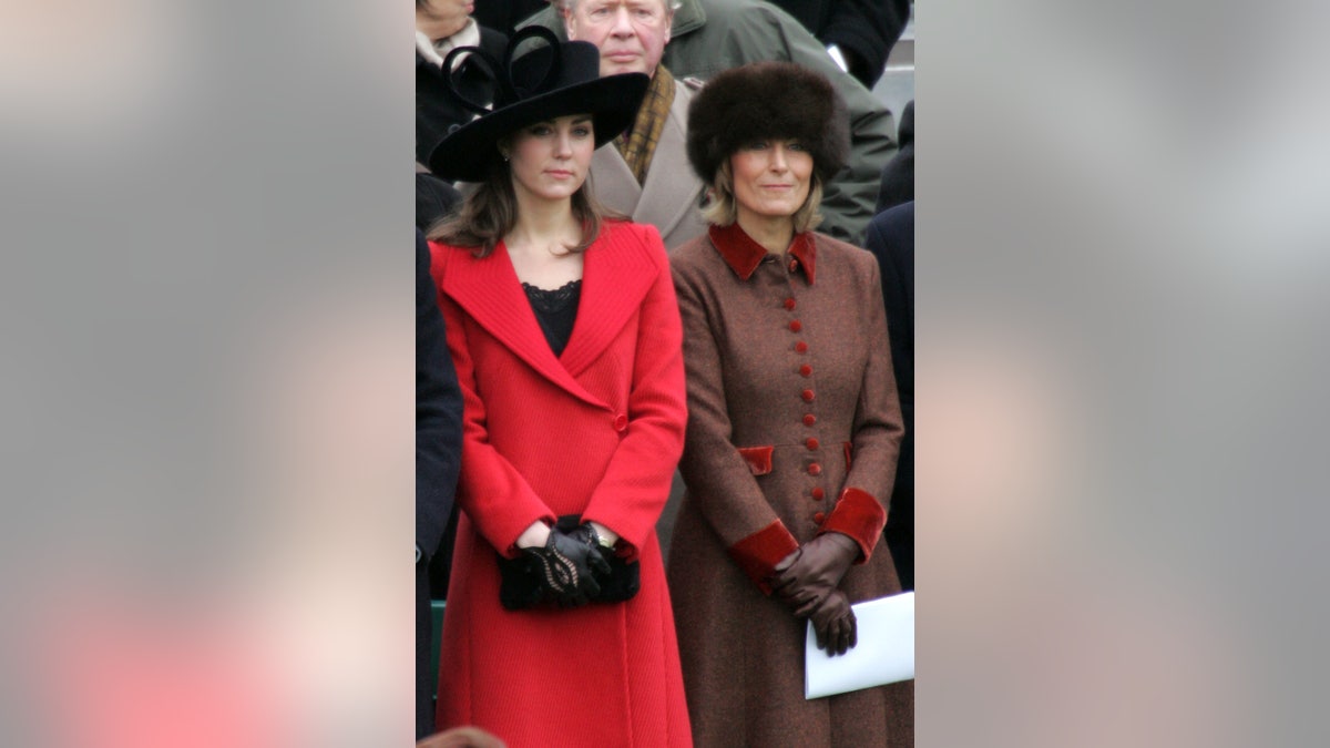 Kate Middleton standing next to Carole Middleton