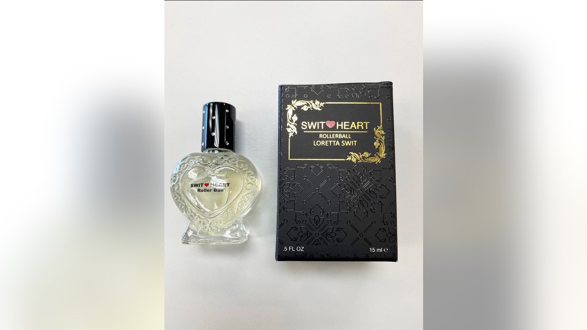 A close-up of Loretta Swits perfume bottle next to the box