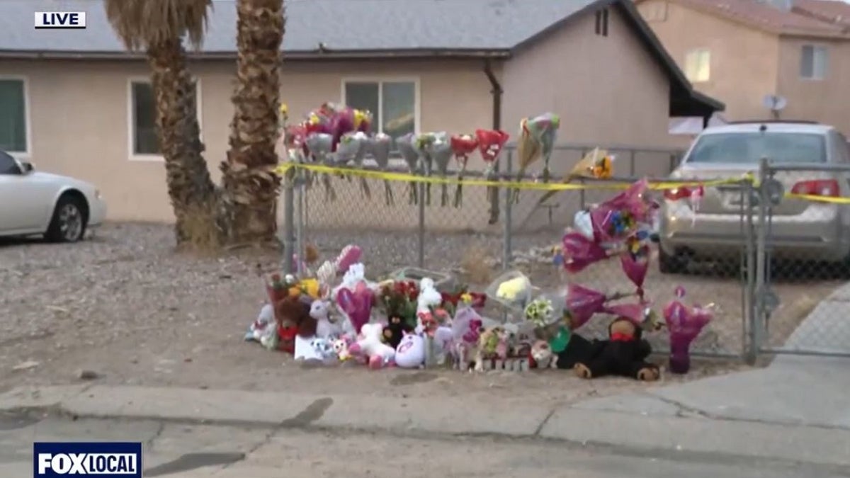 A flower memorial outside a burned home where five children were killed