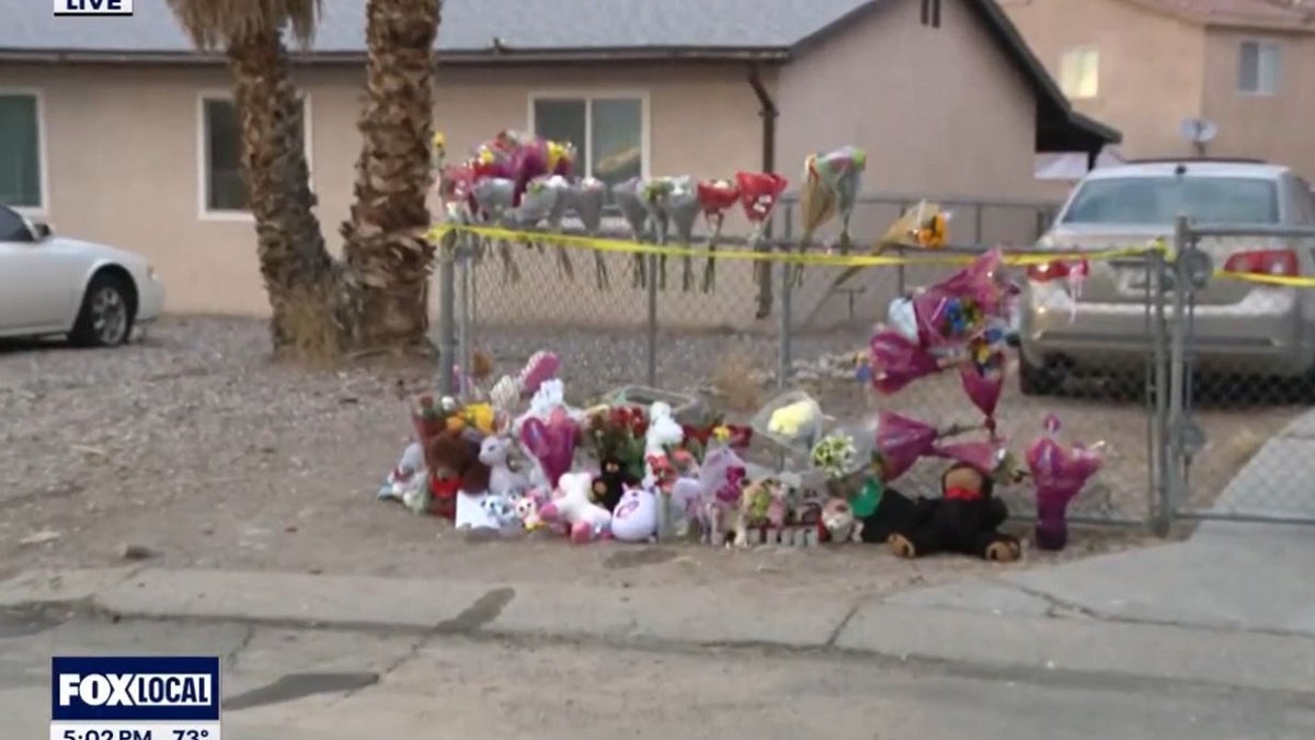 A flower memorial outside a burned home where five children were killed