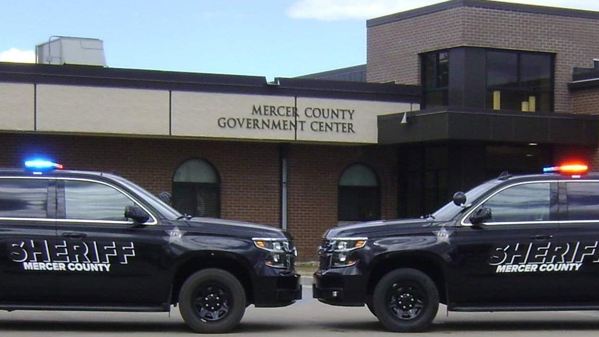 Mercer County patrol vehicles in front of building
