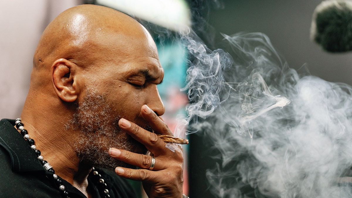 Mike Tyson smokes