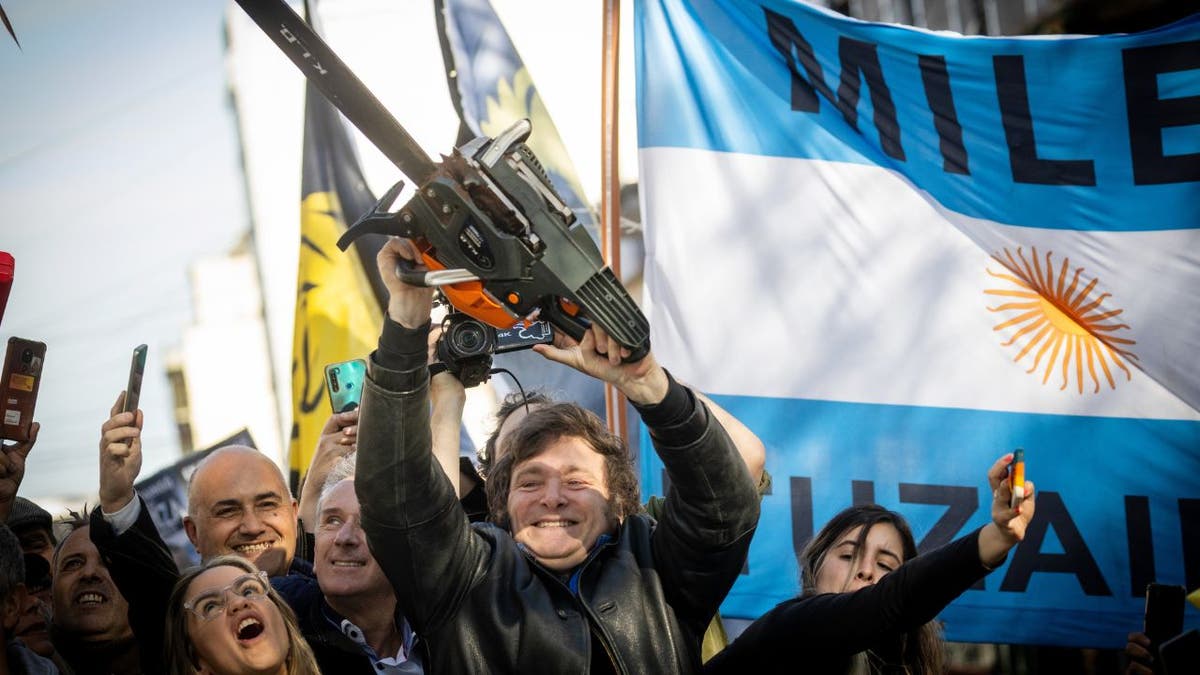 Argentina President Javier Milei lefts a chainsaw into the air while he was a candidate