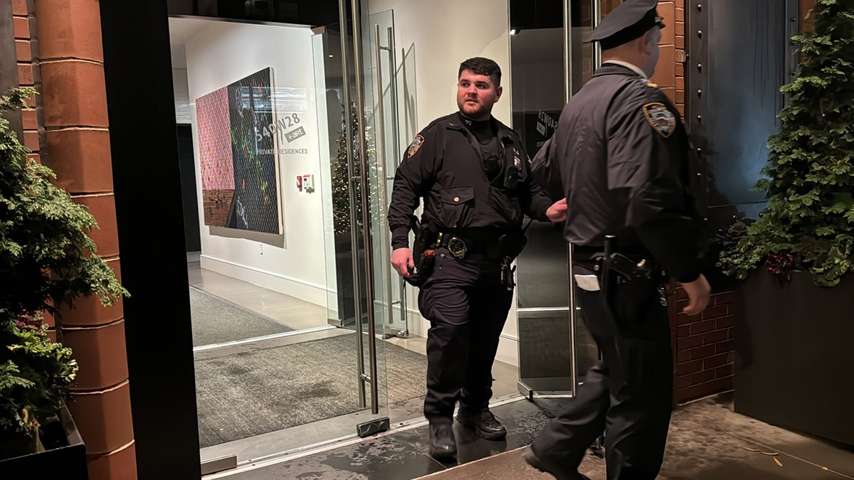 Police seen walking out of condo building