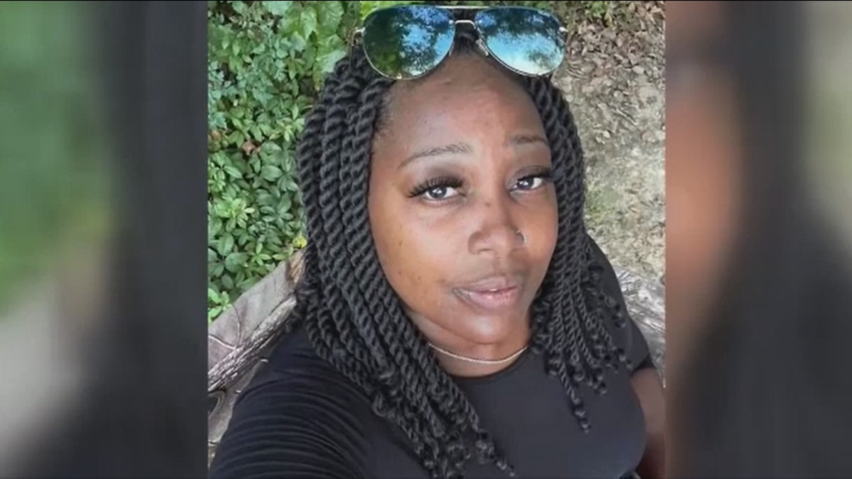 Latasha Crump Coleman poses in a selfie with sunglasses on top of her head
