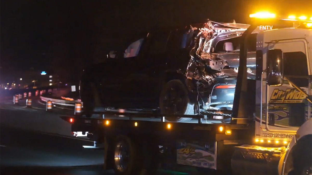 A car sits on a tow truck bed