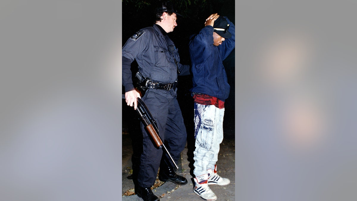 Boston Police officer frisking man in Roxbury
