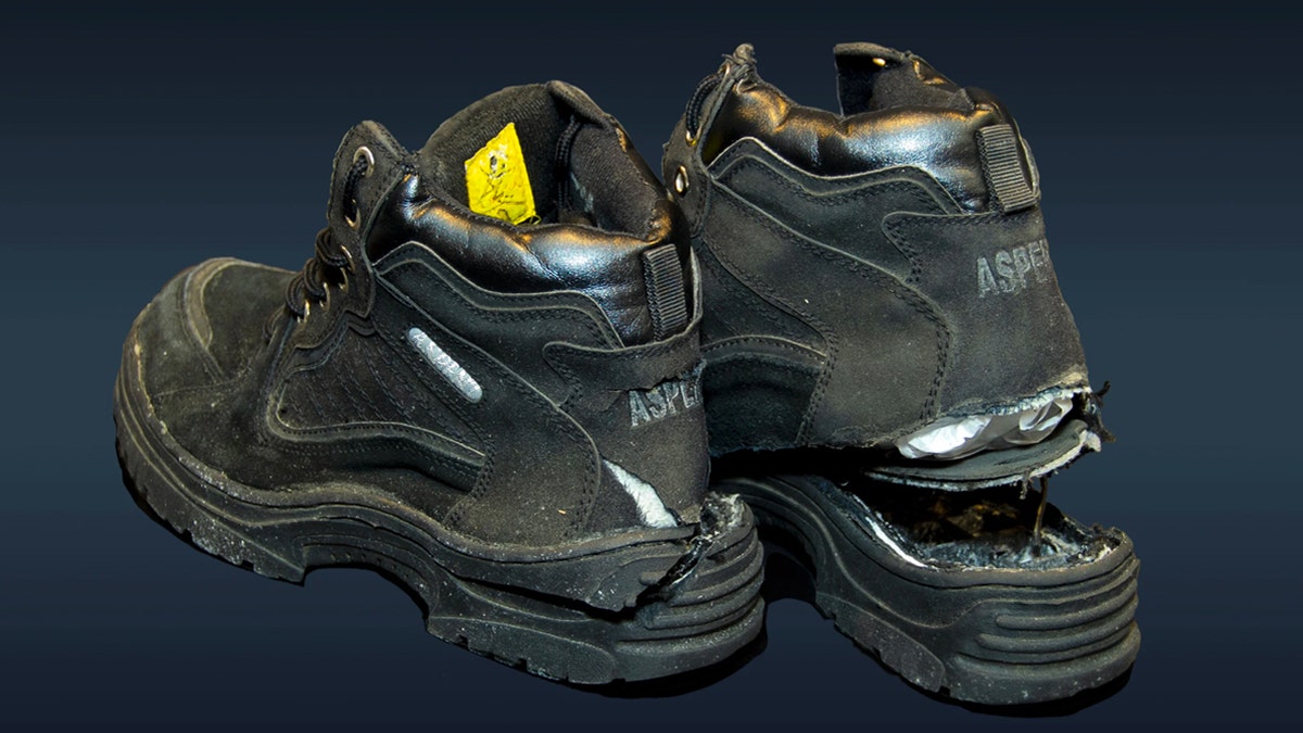 Black Aspen hiking shoes that have had their soles cut open