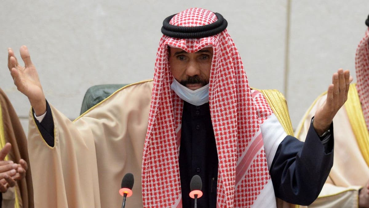 Kuwaiti Emir Sheikh Nawaf Al-Ahmad Al-Jaber Al-Sabah speaks with his hands raised