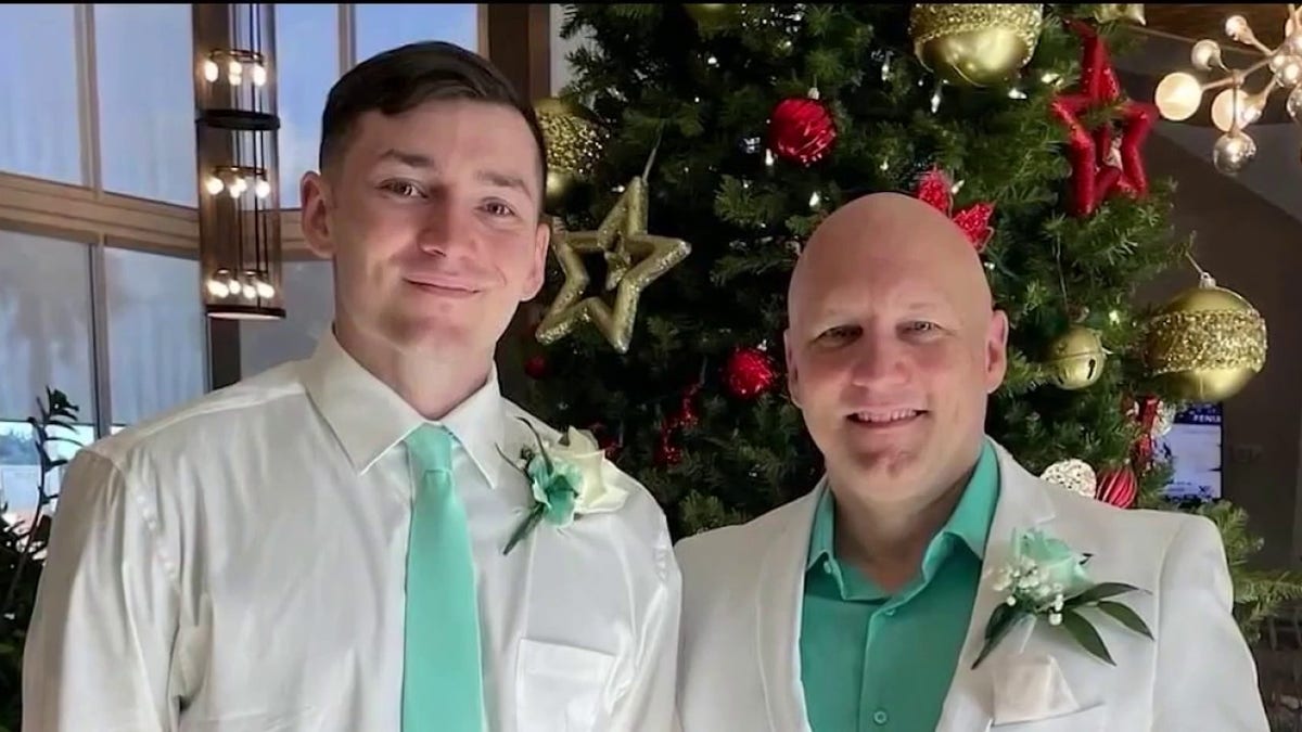 Andrew and his dad Douglas pose during a wedding photo