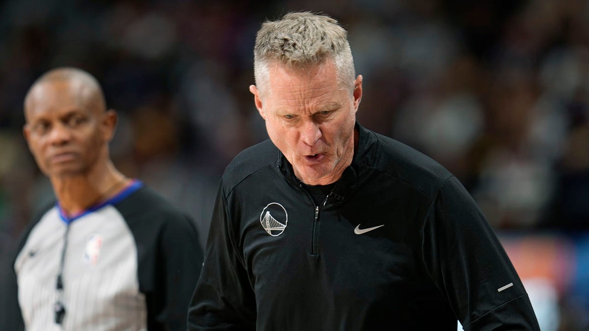 Golden State Warriors head coach Steve Kerr, front, turns away from referee Michael Smith while arguing for a foul call against the Denver Nuggets in the second half of an NBA basketball game, Monday, Dec. 25, 2023, in Denver.