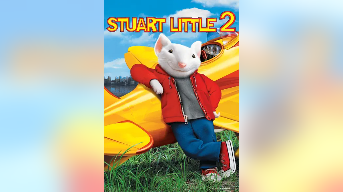 Stuart Little leaning up against airplane