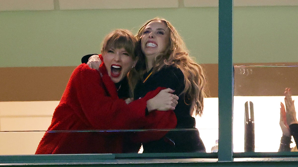 Taylor Swift and Brittany Mahomes hug at a football game