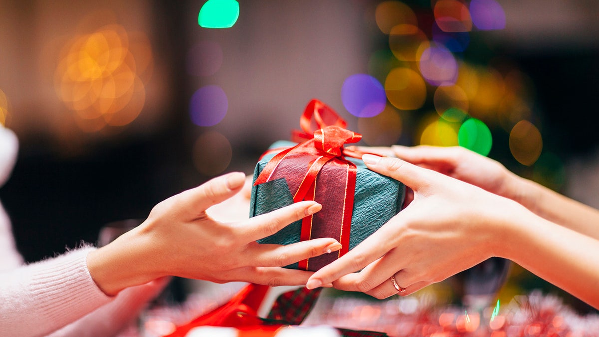 Two sets of hands exchanging a gift