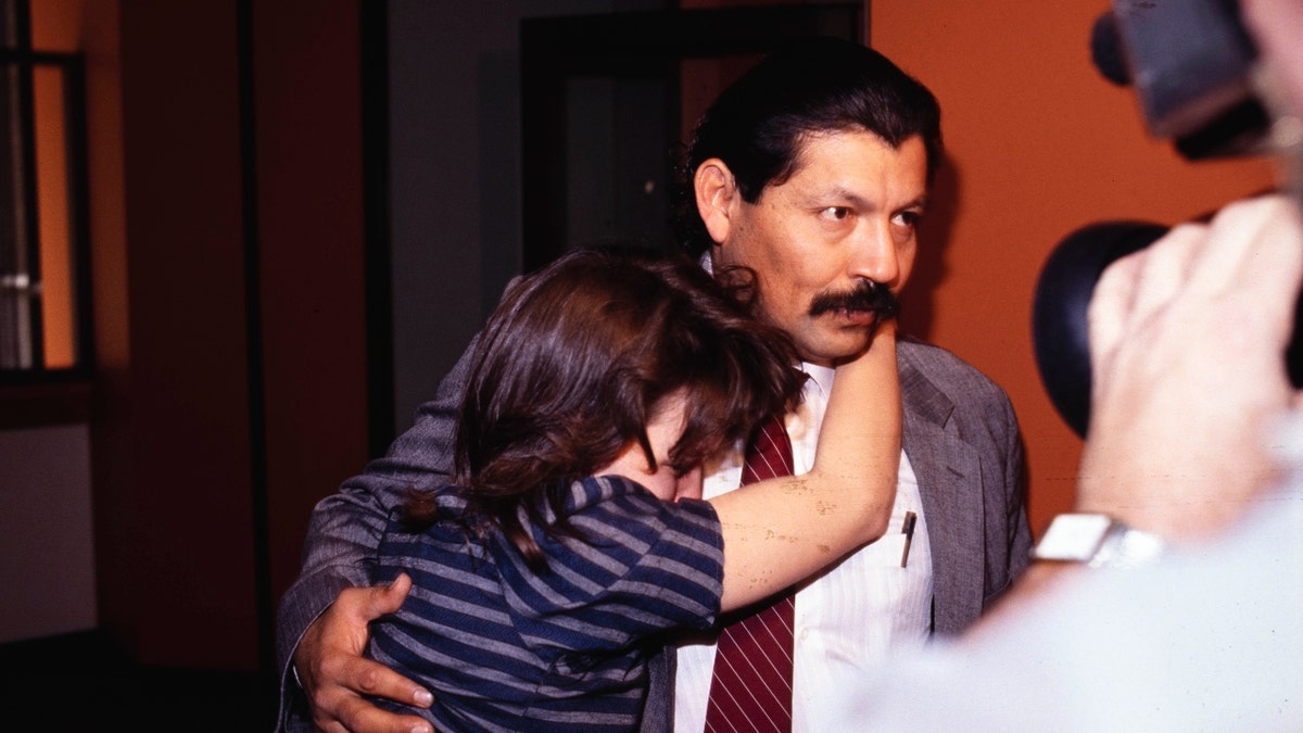 Hector Polanco hugs a woman