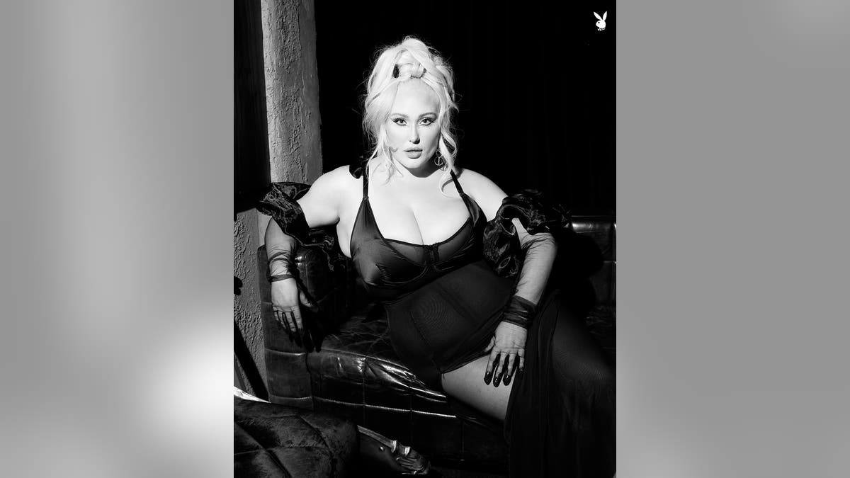 A black and white photo of Hayley Hasselhoff wearing a sheer black dress