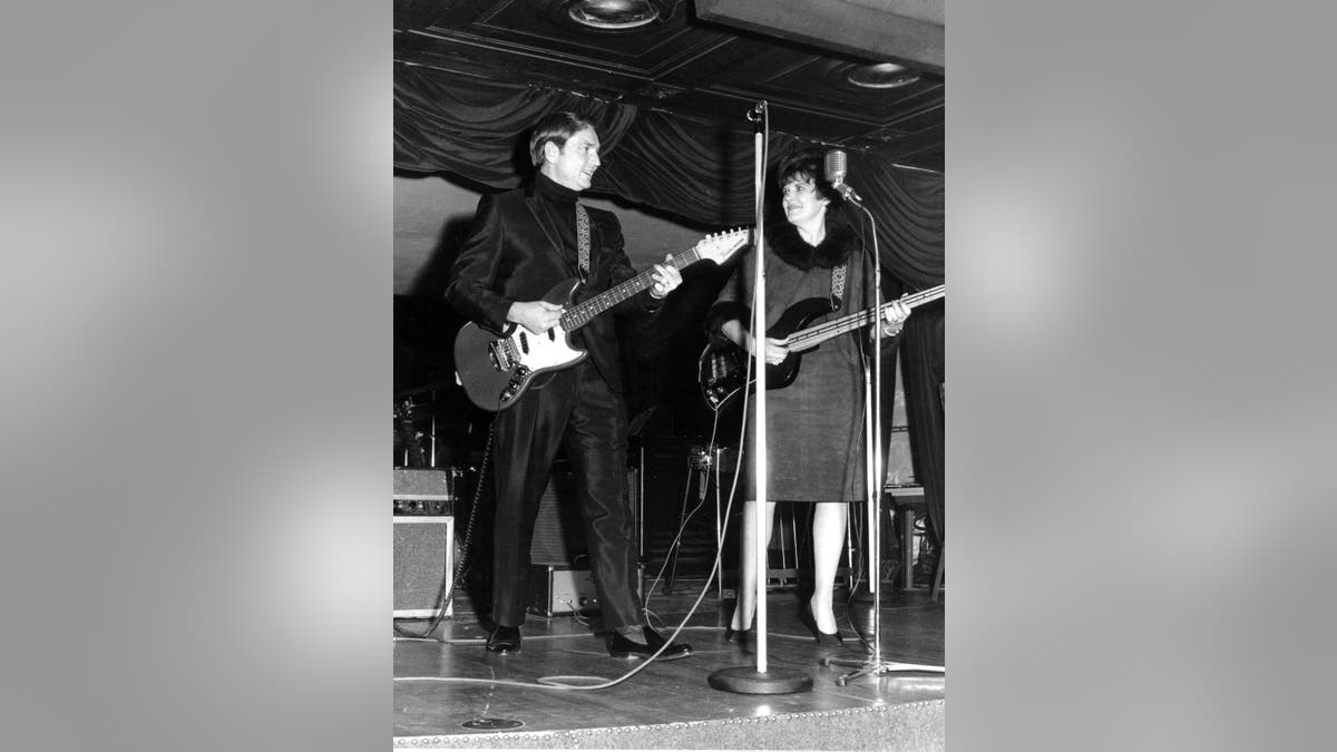 Black and white photo of Willie Nelson and Shirley Collie singing together