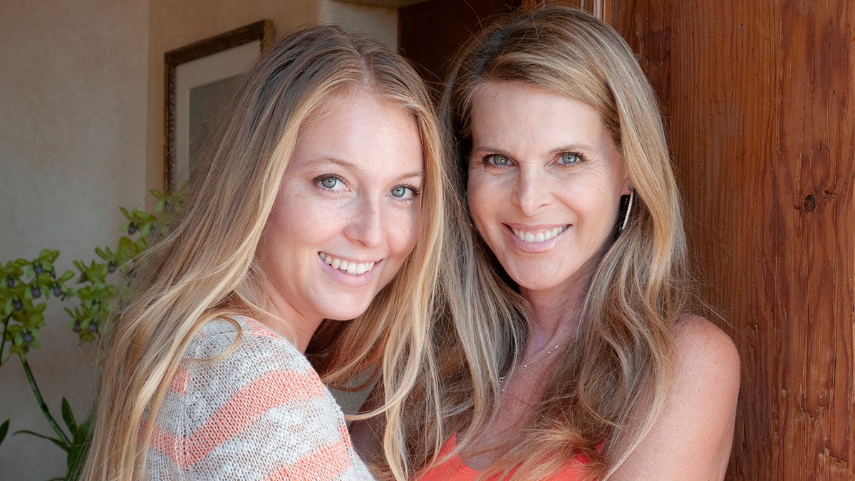 Catherine Oxenberg and daughter India embrace in a hallway