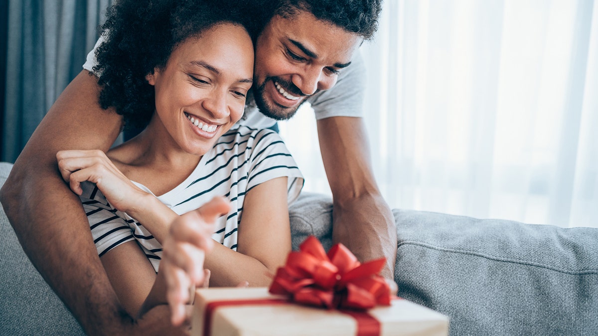 couple opening Christmas gift