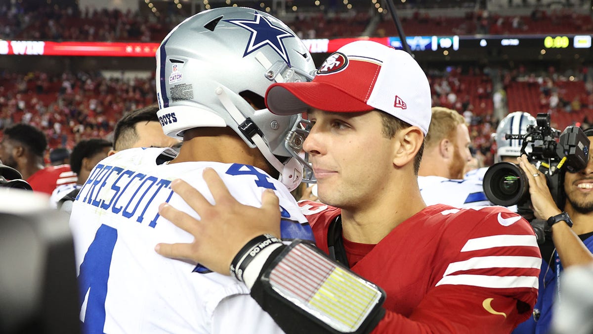 Dak Prescott hugging Brock Purdy