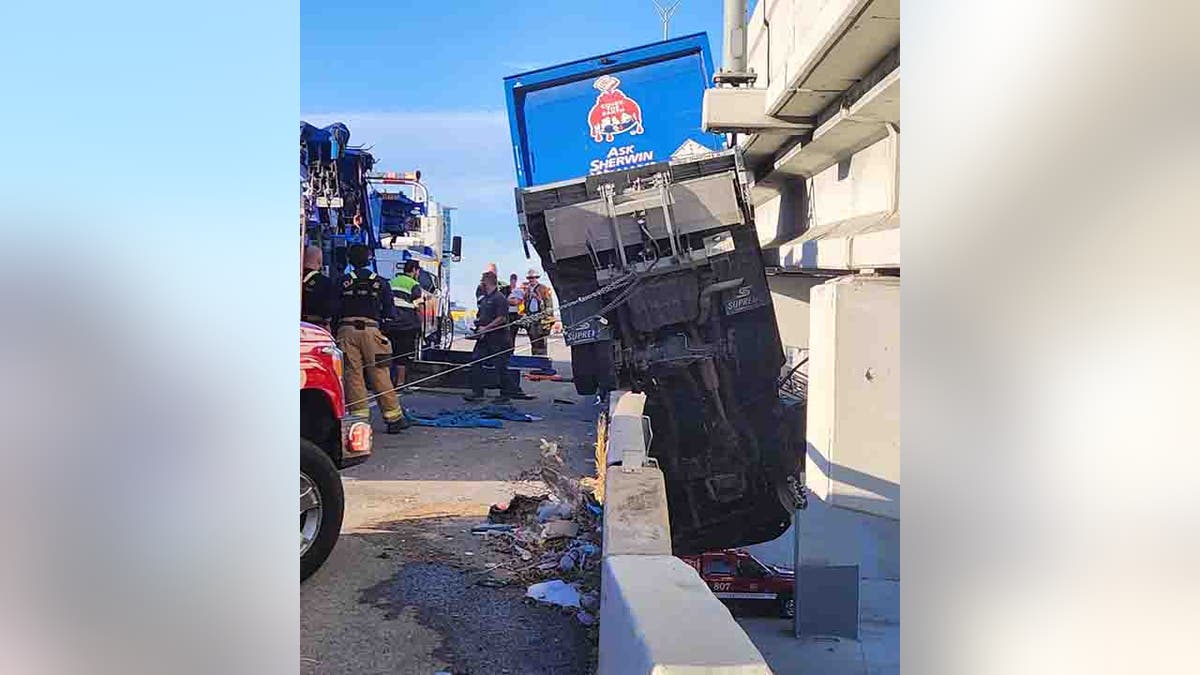 truck hanging off bridge